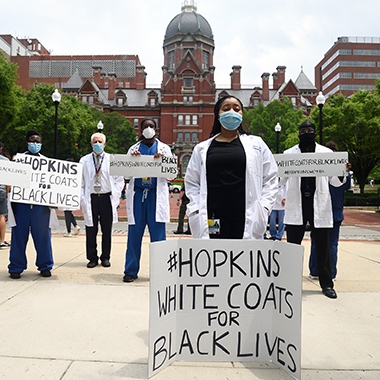 Rothman stands with his colleagues during the white coats for black lives event.
